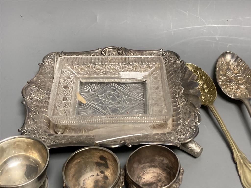 Four silver condiments, two silver thimbles, two Indian? salts and assorted plated flatware etc.